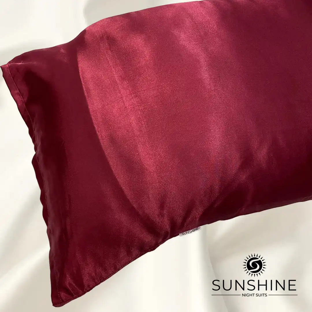 Luxurious maroon silk satin pillowcases with a glossy, elegant finish