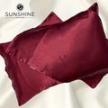 Luxurious maroon silk satin pillowcases with a glossy, elegant finish